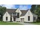 Two-story home with white brick exterior, gray accents, and a three-car garage at 1805 Okeefe Ln # 1D, Raleigh, NC 27613