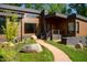 Modern home with wood siding, stone accents, and a walkway leading to the entrance at 31 Meandering Way Ct, Chapel Hill, NC 27516