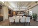 Modern kitchen with dark cabinetry, a large island, and a dining area at 31 Meandering Way Ct, Chapel Hill, NC 27516