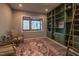 Home office with built-in green shelving, comfortable seating, and a large window at 31 Meandering Way Ct, Chapel Hill, NC 27516