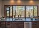 Modern kitchen with dark cabinetry, granite countertops, and stainless steel appliances at 31 Meandering Way Ct, Chapel Hill, NC 27516