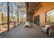 Large deck with pergola, dining table, and rocking chairs, offering scenic wooded views at 31 Meandering Way Ct, Chapel Hill, NC 27516