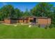 Modern home exterior with wood siding, large windows, and landscaping at 31 Meandering Way Ct, Chapel Hill, NC 27516