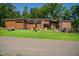 Modern home exterior with wood siding, large windows, and landscaping at 31 Meandering Way Ct, Chapel Hill, NC 27516