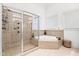 Spa-like bathroom with shower, corner tub, and updated fixtures at 40002 Worth, Chapel Hill, NC 27517