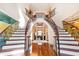 Impressive double staircase with wrought-iron railings and hardwood flooring at 40002 Worth, Chapel Hill, NC 27517