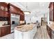 Island kitchen with granite countertops, dark wood cabinets, and stainless steel appliances at 40002 Worth, Chapel Hill, NC 27517