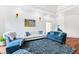 Sitting room with teal and beige sofas, hardwood floors, and a large piece of art at 40002 Worth, Chapel Hill, NC 27517