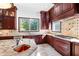 Island kitchen with granite countertops, copper sink, and dark wood cabinets at 40002 Worth, Chapel Hill, NC 27517