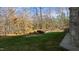 Landscaped backyard with stone retaining wall and trees at 40002 Worth, Chapel Hill, NC 27517