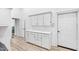 Laundry room with white cabinets, quartz countertops, and built-in storage at 40002 Worth, Chapel Hill, NC 27517