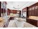 Gourmet kitchen boasts granite countertops, dark wood cabinets, and stainless steel appliances at 40002 Worth, Chapel Hill, NC 27517