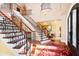 View of the staircase from the foyer, showing the ornate railing and hardwood at 40002 Worth, Chapel Hill, NC 27517