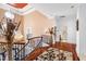 Stunning hallway showcasing hardwood floors, chandelier, and wrought-iron railing at 40002 Worth, Chapel Hill, NC 27517