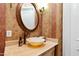 Powder room with an ornate vessel sink and decorative wallpaper at 40002 Worth, Chapel Hill, NC 27517