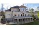 Back of house showing stone and stucco exterior, large deck, and landscaping at 40002 Worth, Chapel Hill, NC 27517