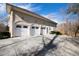 Three-car garage with white doors and a long driveway at 40002 Worth, Chapel Hill, NC 27517