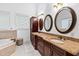 Elegant bathroom with double vanity, soaking tub, and large mirrors at 40002 Worth, Chapel Hill, NC 27517
