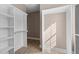 Spacious walk-in closet with built-in shelving and hanging rods at 4268 Jacks Creek Trl, Burlington, NC 27215