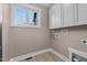 Laundry room with white cabinets and vinyl flooring at 4268 Jacks Creek Trl, Burlington, NC 27215
