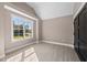 Bedroom with large window, wood-look floors, and a view at 4268 Jacks Creek Trl, Burlington, NC 27215