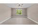 Bright bedroom featuring wood-look floors and a large window at 4268 Jacks Creek Trl, Burlington, NC 27215