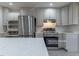 Updated kitchen with stainless steel appliances and white cabinets at 904 Grove St, Chapel Hill, NC 27517