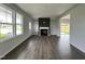 Living room with fireplace, built-in shelving, hardwood floors and view to dining area at 40 Longbow Dr, Middlesex, NC 27557