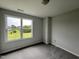 Bright bedroom with carpeted floor and a large window offering a view of the backyard at 40 Longbow Dr, Middlesex, NC 27557