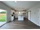 Modern kitchen with white cabinets, quartz countertops, and stainless steel appliances, and sliding glass door to backyard at 40 Longbow Dr, Middlesex, NC 27557