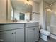 Bathroom with double vanity, gray cabinets, and a walk-in shower at 40 Longbow Dr, Middlesex, NC 27557