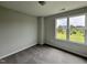 Spacious bedroom featuring a large window with a picturesque view and neutral wall tones at 40 Longbow Dr, Middlesex, NC 27557