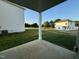 Covered patio overlooking grassy backyard with views of neighboring homes at 116 Commons Cir # 229, Clayton, NC 27520