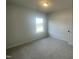 Spacious bedroom with large window and view of neighborhood at 116 Commons Cir # 229, Clayton, NC 27520