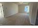 Spacious bedroom with neutral carpeting and large window at 116 Commons Cir # 229, Clayton, NC 27520