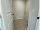 Bright laundry room with tile floor, ready for your washer and dryer at 116 Commons Cir # 229, Clayton, NC 27520