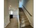 Modern staircase with dark metal railing leading to the upper level at 116 Commons Cir # 229, Clayton, NC 27520