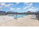 Community swimming pool with lounge chairs and accessibility ramp at 116 Commons Cir # 229, Clayton, NC 27520