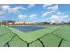 Two community tennis courts with green surface and fencing at 116 Commons Cir # 229, Clayton, NC 27520