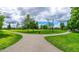 Paved walking path through a grassy park with trees at 116 Commons Cir # 229, Clayton, NC 27520