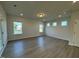 Spacious bedroom with hardwood floors and large windows offering natural light at 116 Commons Cir # 229, Clayton, NC 27520