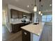 Modern kitchen with dark brown cabinets, white countertops and stainless steel appliances at 116 Commons Cir # 229, Clayton, NC 27520