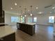 Modern kitchen with island, stainless steel appliances, and hardwood floors at 116 Commons Cir # 229, Clayton, NC 27520