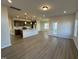 Open living room and kitchen with hardwood floors and neutral colors at 116 Commons Cir # 229, Clayton, NC 27520