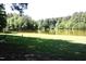 Serene lakefront lot with lush lawn and mature trees at 7647 Cummings Dr, Mebane, NC 27302