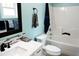 Clean bathroom with white tub, vanity, and tile at 7647 Cummings Dr, Mebane, NC 27302