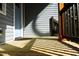 Front porch with wood flooring and gray siding at 7647 Cummings Dr, Mebane, NC 27302