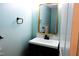 Small bathroom with vanity, toilet, and decorative mirror at 7647 Cummings Dr, Mebane, NC 27302