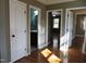 Bright hallway with hardwood floors and access to bedrooms and bathroom at 7647 Cummings Dr, Mebane, NC 27302