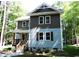Two-story house with gray and brown siding, front porch and stairs at 7647 Cummings Dr, Mebane, NC 27302